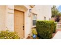 Tan front door with ADT security alarm visible at 9333 Leaping Deer Pl # 102, Las Vegas, NV 89178