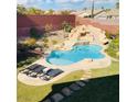 Inviting backyard pool with rock waterfall feature and lounge chairs for relaxation and enjoyment at 5301 Fairbranch Ln, Las Vegas, NV 89135