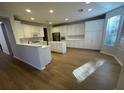 Spacious kitchen with island, white cabinets, and light flooring at 1335 Temporale Dr, Henderson, NV 89052