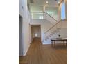 Two-story living room, high ceilings, hardwood floors, and staircase at 1335 Temporale Dr, Henderson, NV 89052