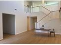 Two-story living room with high ceilings and hardwood floors at 1335 Temporale Dr, Henderson, NV 89052