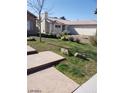 View of the backyard showing grass and rock landscaping on a sunny day at 3505 Benson Ln, North Las Vegas, NV 89032