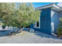 A view of the home's side yard featuring mature landscaping and seating at 3301 Rodeo Ave, Pahrump, NV 89048