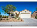 Single-story house with a two-car garage and mature tree in front at 3320 Kookaburra Way, North Las Vegas, NV 89084