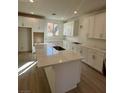 Modern kitchen with white cabinets and large island at 1441 Nocturnal Flight St, Las Vegas, NV 89138