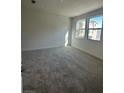 Bright bedroom featuring neutral carpeting and large windows at 1448 Nocturnal Flight St, Las Vegas, NV 89138