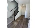 Modern entryway with wood-look floors and a sleek staircase at 1448 Nocturnal Flight St, Las Vegas, NV 89138