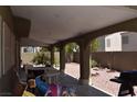 Covered patio with arched supports, adjacent to a gravel backyard at 1708 Walrus St, Las Vegas, NV 89117