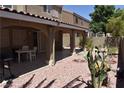 Covered patio, gravel yard, cactus, and small table with chairs at 1708 Walrus St, Las Vegas, NV 89117