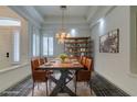 Elegant dining room with a rustic wooden table and leather chairs at 1860 E Ford Ave, Las Vegas, NV 89123