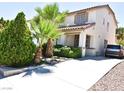 Two-story house with a driveway and lush landscaping at 7917 Sally Irene Ct, Las Vegas, NV 89113