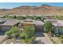 Modern house with desert landscaping and mountain backdrop at 10057 Regency Canyon Way, Las Vegas, NV 89148