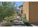 Landscaped front yard with a walkway and gated entry at 10057 Regency Canyon Way, Las Vegas, NV 89148