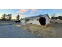 Ranch style home with solar panels and gravel driveway at 1310 Fremont St, Pahrump, NV 89048