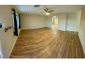 Spacious living room with wood-look floors and ceiling fan at 1310 Fremont St, Pahrump, NV 89048