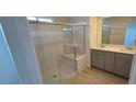 Bathroom featuring a glass shower, double sinks, and modern fixtures at 7086 Parkallen Ave, Las Vegas, NV 89113