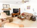 Living room with fireplace, neutral colored couch and large TV at 1680 Landmark Ave, Pahrump, NV 89060