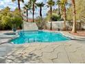 Relaxing pool and patio area with stone accents at 9917 Aspen Knoll Ct, Las Vegas, NV 89117