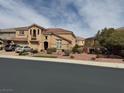 Charming two-story home with a red tile roof, multiple-car garage, and landscaped front yard at 2742 Kingclaven Dr, Henderson, NV 89044