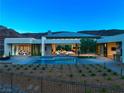 Modern backyard with a sleek pool and lush desert landscaping, perfect for relaxation and outdoor enjoyment at 6 Rockmount Ct, Henderson, NV 89012