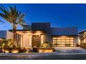 Modern home with sleek design, palm trees, and landscaped yard at 678 Blackrock Rim Dr, Henderson, NV 89012