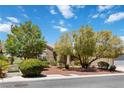 Lovely single-story home with meticulously maintained landscaping, mature shade trees, and three car garage at 1629 Black Fox Canyon Rd, Henderson, NV 89052