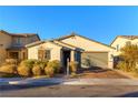 Charming single-story home with a neutral exterior, brick driveway, and well-maintained landscaping at 3716 W Colton Ave, North Las Vegas, NV 89032