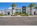 Daytime shot of a modern home with meticulously landscaped yard and a striking black and white facade at 9760 Solar Ave, Las Vegas, NV 89149