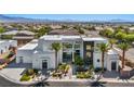 Striking modern home with black brick and white stucco exterior, complemented by palm trees at 9760 Solar Ave, Las Vegas, NV 89149