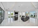 Contemporary living room features plush seating, large windows, and a modern entertainment center at 9760 Solar Ave, Las Vegas, NV 89149