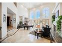 Grand living room featuring soaring ceilings, abundant natural light, and a pool table at 2349 Villandry Ct, Henderson, NV 89074