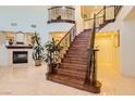 Grand two-story entryway with elegant staircase and tile flooring at 2109 Humble Hollow Pl, North Las Vegas, NV 89084