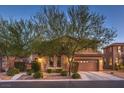 Two-story home with charming landscaping and a three-car garage at 8429 Brackenfield Ave, Las Vegas, NV 89178