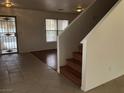 Home entryway with tiled floors and wooden staircase at 6449 Elizabethtown Ave, Las Vegas, NV 89110