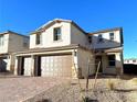 Two-story house with brown double-door garage and brick driveway at 9886 Belikove Manor Ave, Las Vegas, NV 89178