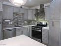 Modern kitchen with stainless steel appliances and gray cabinets at 5900 Gordon Ave, Las Vegas, NV 89108