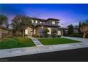 Elegant two-story home with manicured landscaping and inviting facade glows softly in the evening light at 17 Winding Rd, Henderson, NV 89052