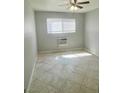 Bright bedroom with tiled floors, window and ceiling fan at 5370 Swenson St # 47, Las Vegas, NV 89119