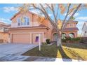 Two-story house with three-car garage and a large tree in the yard at 2257 Loring Ave, Henderson, NV 89074