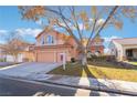 Two-story house with three-car garage and well-manicured lawn at 2257 Loring Ave, Henderson, NV 89074