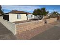 House exterior with a landscaped front yard and block wall at 132 W Victory Rd, Henderson, NV 89015