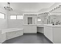 Elegant bathroom with marble finishes, a soaking tub, and modern fixtures at 2761 Cape Hope Way, Las Vegas, NV 89121