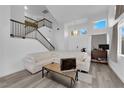 Bright and airy living room features hardwood floors, high ceilings, and a staircase with black railings at 2196 Pescara Ct, Las Vegas, NV 89123