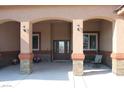 Covered entrance with decorative stone pillars, double doors, and seating at 1120 W Gray Fox Way, Pahrump, NV 89048