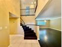 Elegant entryway with dark wood staircase and tile flooring at 4005 Paul Robarts Ct, Las Vegas, NV 89102