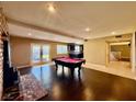 Spacious game room with pool table, fireplace, and dark hardwood floors at 4005 Paul Robarts Ct, Las Vegas, NV 89102