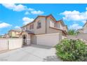 Two-story house with attached garage, and a landscaped front yard with bushes at 10596 Corte Sierra St, Las Vegas, NV 89183