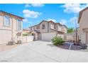 Two-story house with attached garage and a landscaped front yard, viewed from the side at 10596 Corte Sierra St, Las Vegas, NV 89183