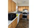 Bright kitchen with wood cabinets, white countertops, and modern stainless steel appliances at 8216 Carmen Blvd, Las Vegas, NV 89128