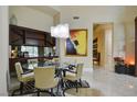 Elegant dining room features a glass-top table, stylish chairs, and a statement art piece at 2877 Paradise Rd # 104, Las Vegas, NV 89109